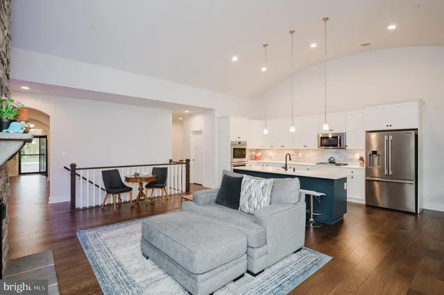 a kitchen with a sink stainless steel appliances and white cabinets