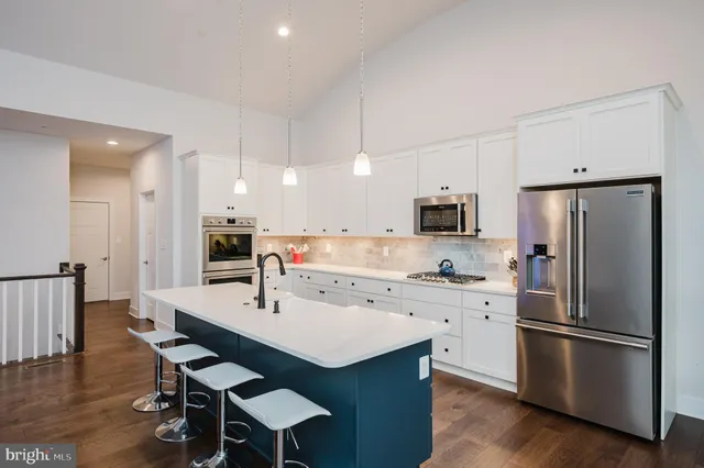 a kitchen with stainless steel appliances a sink stove and cabinets