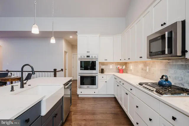 a large white kitchen with a large window
