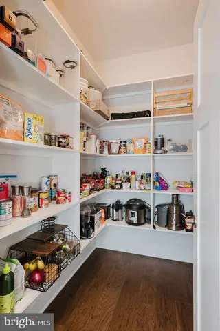 a spacious bathroom with a double vanity sink a mirror and a shower