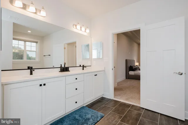 a living room with furniture and a wall painting