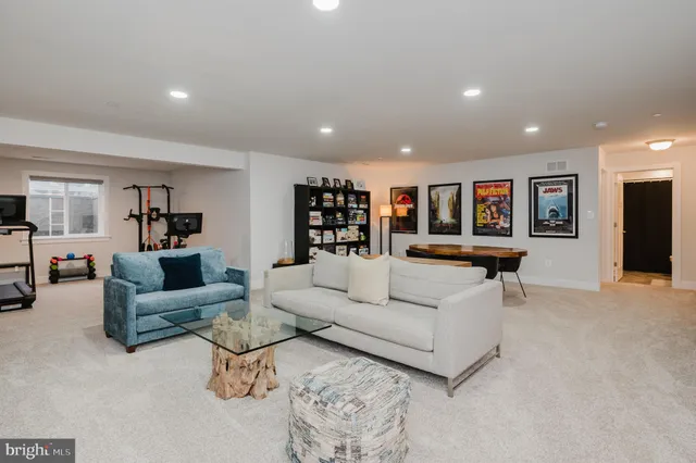 a view of a patio with a dining table and chairs next to a yard