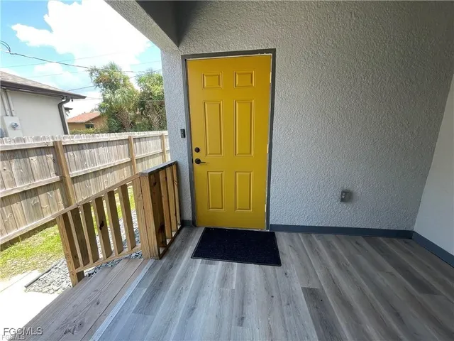 a view of front door deck and wooden floor