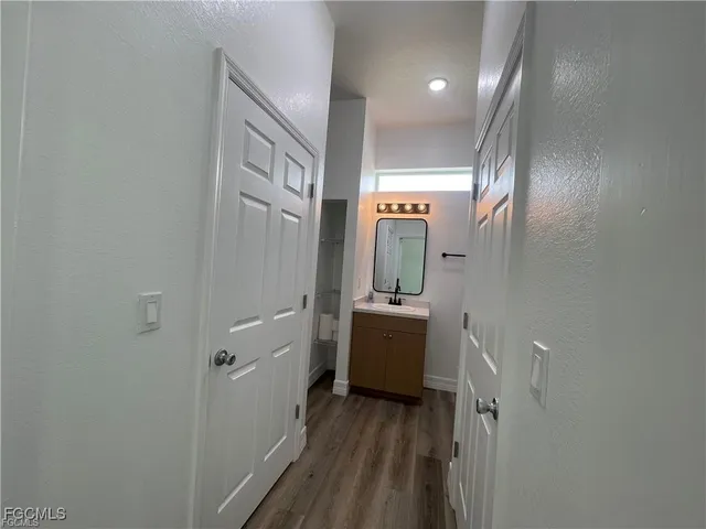 walk in closet with view of bathroom