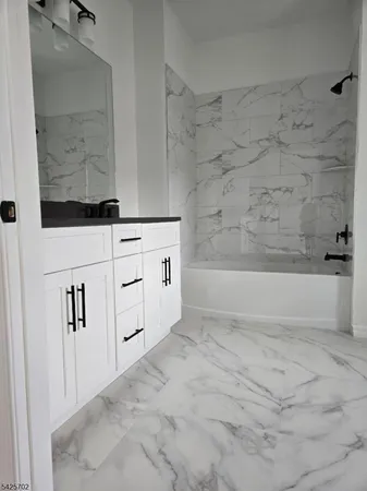 a bathroom with a bathtub and shower
