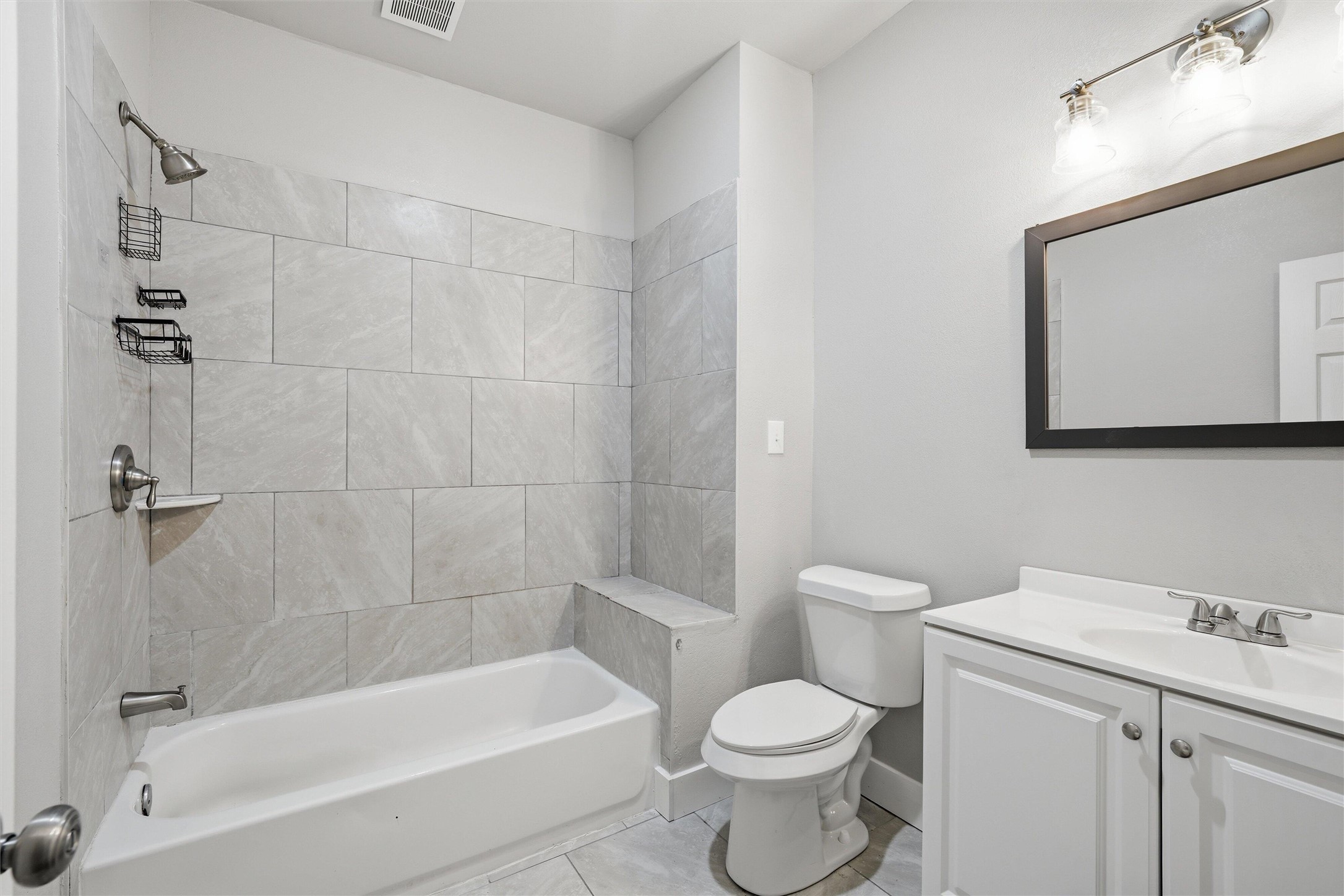 803 North 3rd Street Temple, TX 76501 - Photo 10 of 22 a bathroom with a toilet a sink a mirror and bathtub