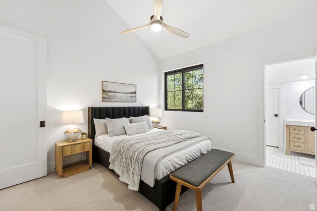 3027 Homestead Road Park City, UT 84098 - Photo 34 of 62 Vaulted ceiling bedroom featuring a modern ceiling fan, large window with black trim, and light-toned carpeting