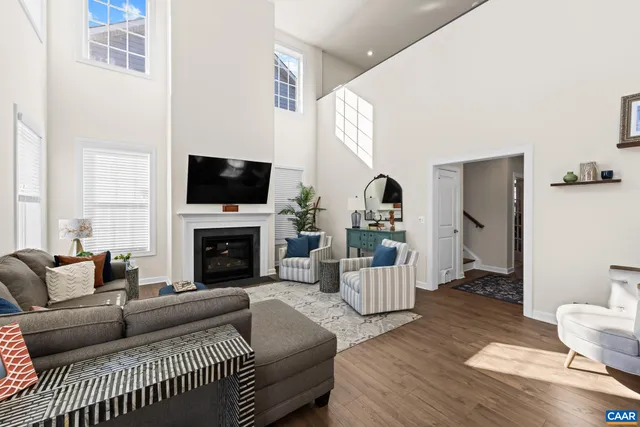 a kitchen with stainless steel appliances granite countertop a stove a sink a refrigerator and a wooden floor