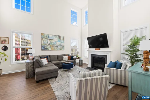 a kitchen with stainless steel appliances granite countertop a stove a sink a refrigerator and a wooden floor