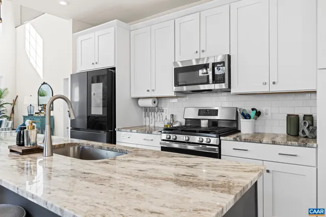 a kitchen with center island table and chairs