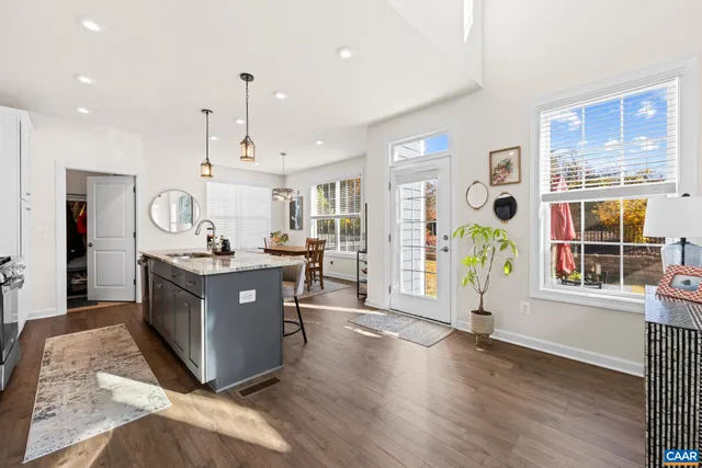 a kitchen with stainless steel appliances granite countertop a sink a stove and a refrigerator
