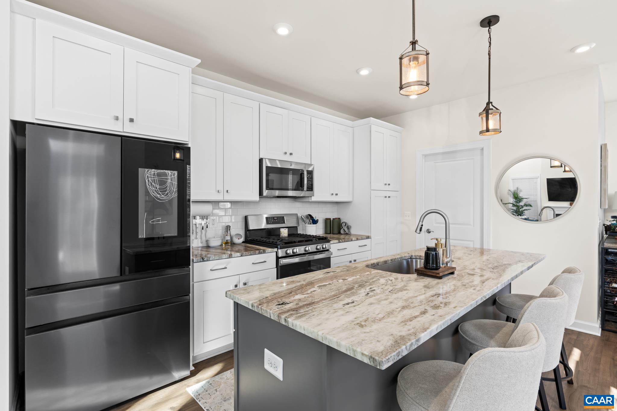 3490 Thicket Run Place Charlottesville, VA 22911 - Photo 18 of 63 a kitchen with stainless steel appliances granite countertop a sink refrigerator and microwave