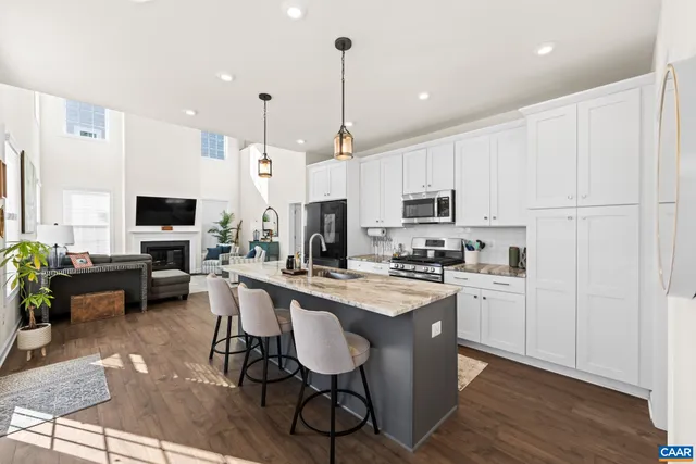a living room with furniture a rug and a window