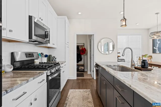 a kitchen with center island table and chairs