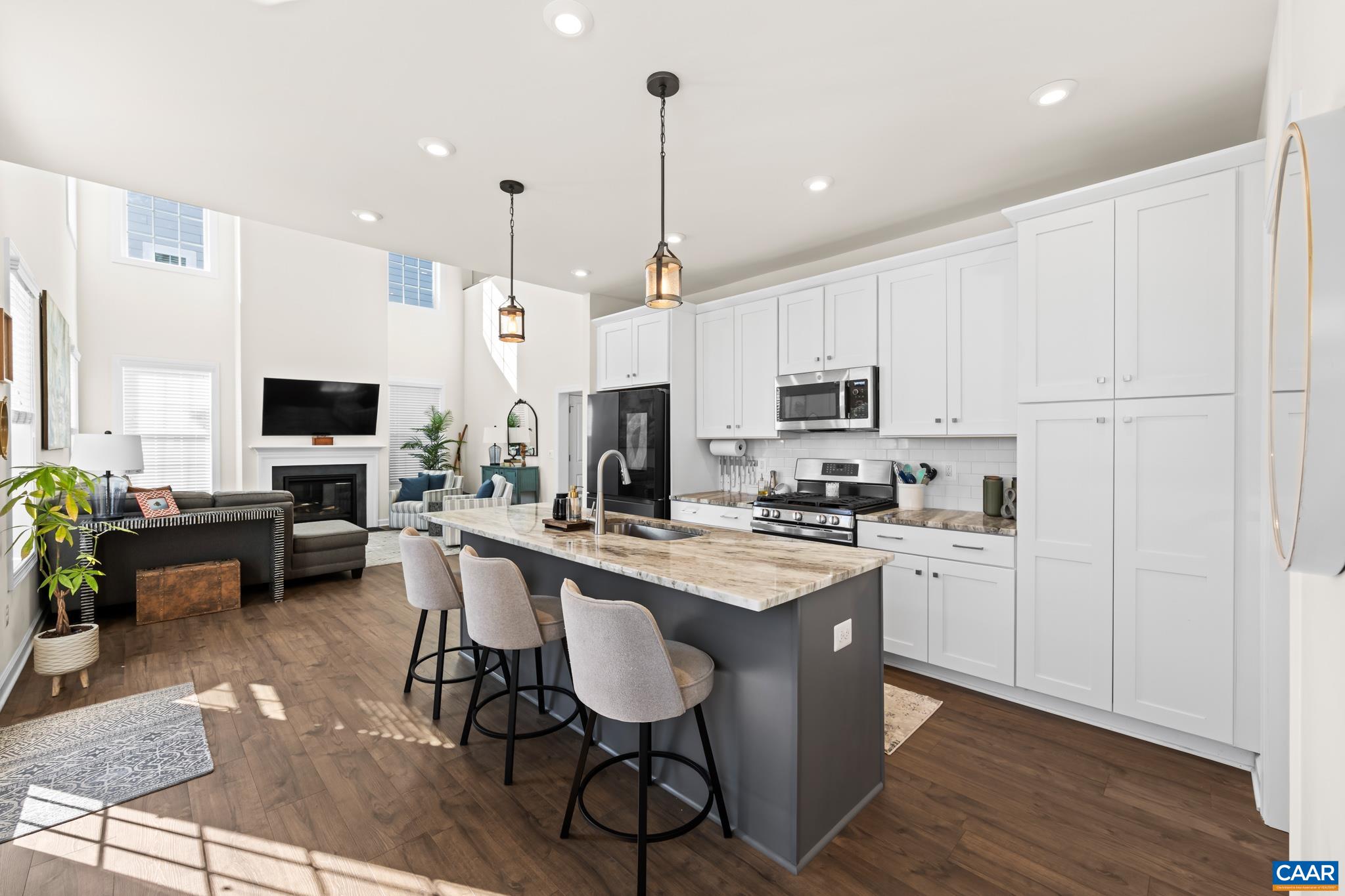 3490 Thicket Run Place Charlottesville, VA 22911 - Photo 23 of 63 a kitchen with stainless steel appliances granite countertop a stove top oven a sink dishwasher a refrigerator and white cabinets with wooden floor