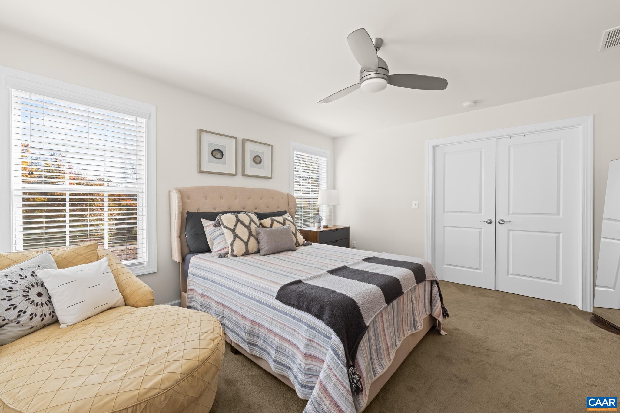 3490 Thicket Run Place Charlottesville, VA 22911 - Photo 28 of 63 a bedroom with a large bed and a couch