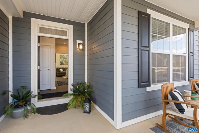 a living room with furniture a rug and a window