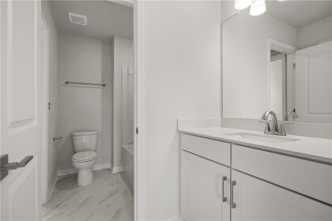 552 Hydrangea Street, Unit LOT 66 Seneca, SC 29678 - Photo 23 of 31 A well-appointed bathroom features a single vanity with ample counter space and a modern toilet.