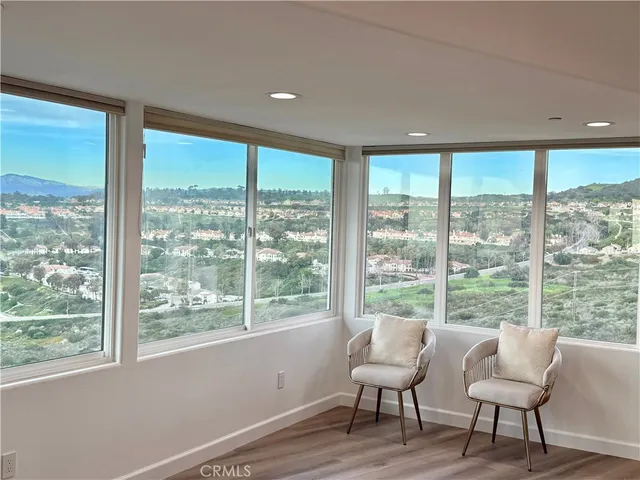 a view of a room with furniture and wooden floor