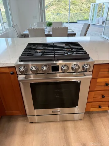 a stove top oven sitting inside of a kitchen