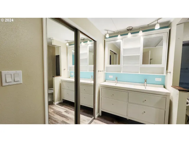 a bathroom with a sink double vanity and a mirror