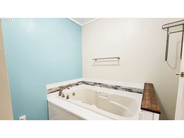 a bathroom with a bathtub and shower