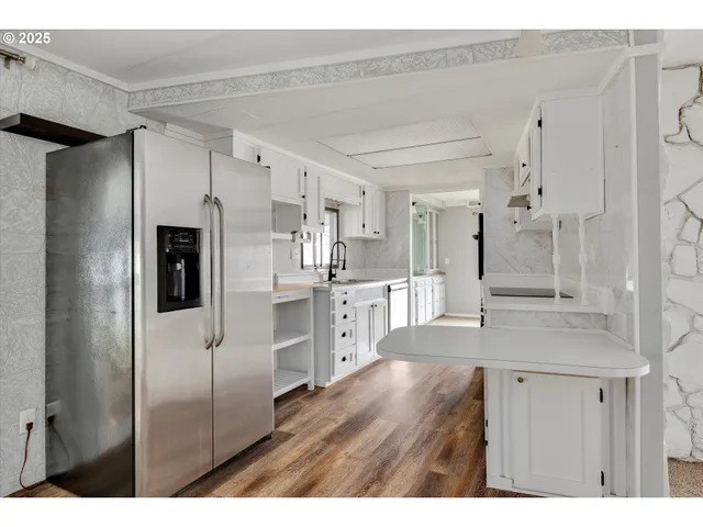 a kitchen with stainless steel appliances cabinets a island and a counter top space