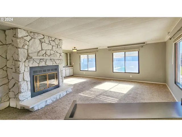 a black and white photo of a livingroom with a fireplace