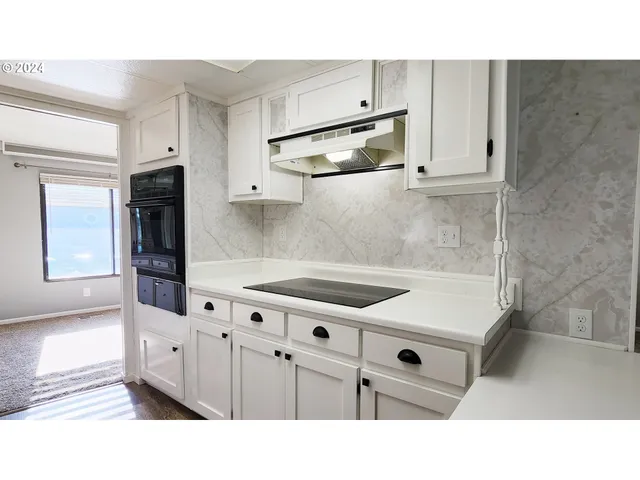 a kitchen with stainless steel appliances kitchen island granite countertop a sink and cabinets