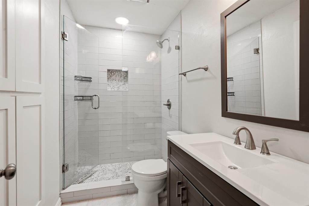7354 Walling Lane Dallas, TX 75231 - Photo 20 of 28 a bathroom with a sink toilet and shower