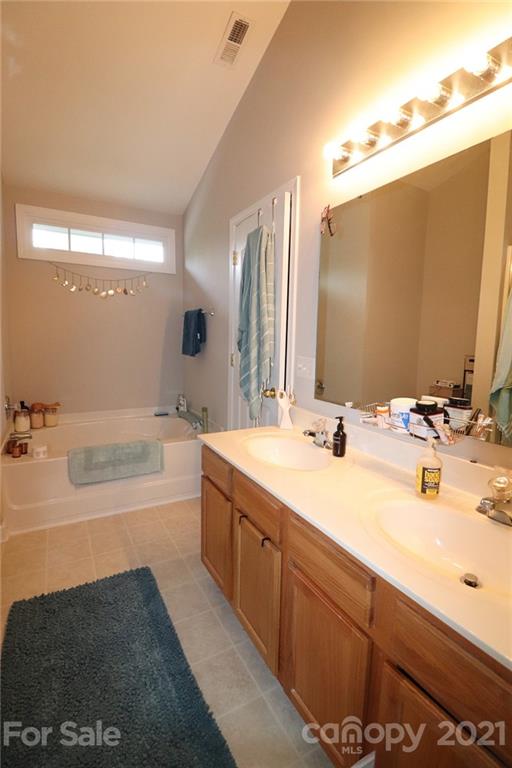 1139 Market Street Fort Mill, SC 29708 - Photo 12 of 17 a bathroom with a tub sink and mirror