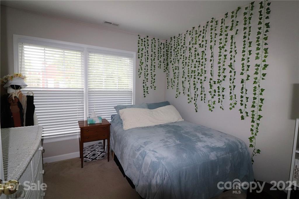 1139 Market Street Fort Mill, SC 29708 - Photo 4 of 17 a bed sitting in a bedroom next to a window