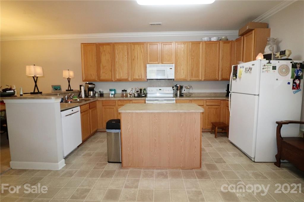 1139 Market Street Fort Mill, SC 29708 - Photo 5 of 17 a kitchen with a sink a stove a refrigerator and cabinets