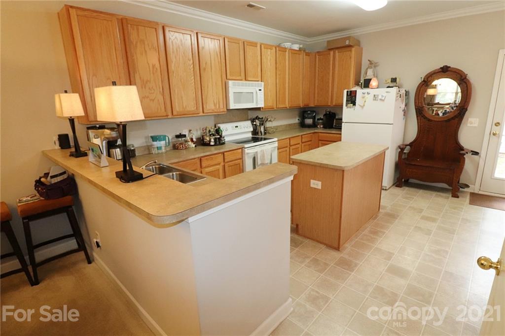 1139 Market Street Fort Mill, SC 29708 - Photo 6 of 17 a kitchen with a stove a refrigerator and a more cabinets
