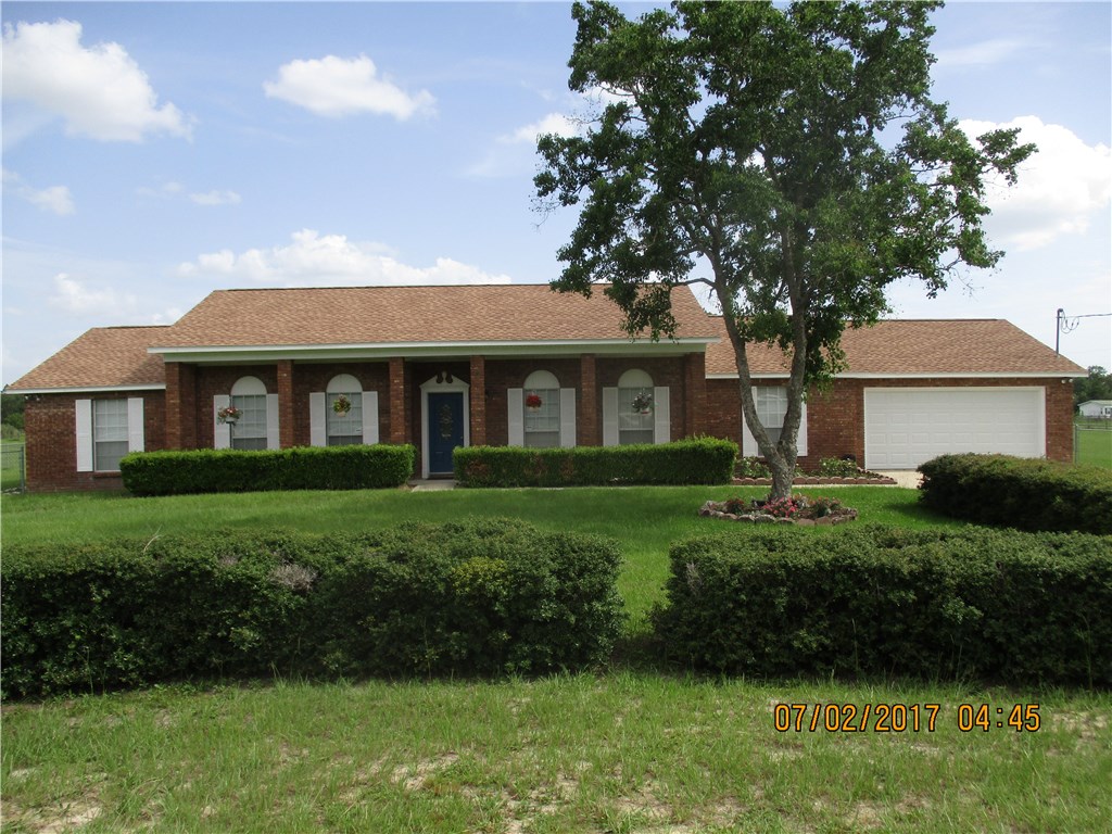 28296 Trigg Road Hilliard, FL 32046 - Photo 1 of 34 a front view of a house with a yard