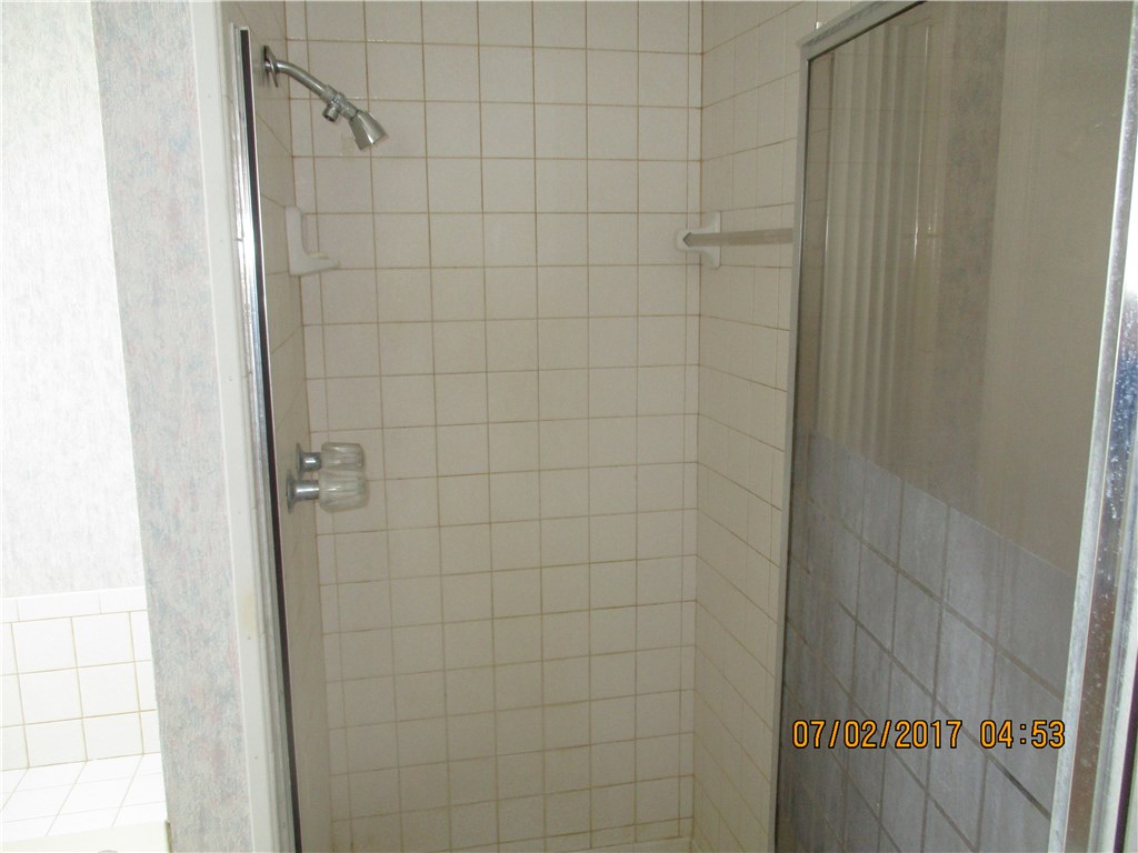 28296 Trigg Road Hilliard, FL 32046 - Photo 18 of 34 a bathroom with a shower