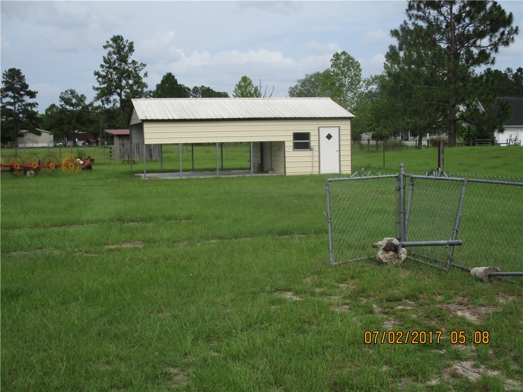 28296 Trigg Road Hilliard, FL 32046 - Photo 20 of 34 a view of a house with a backyard