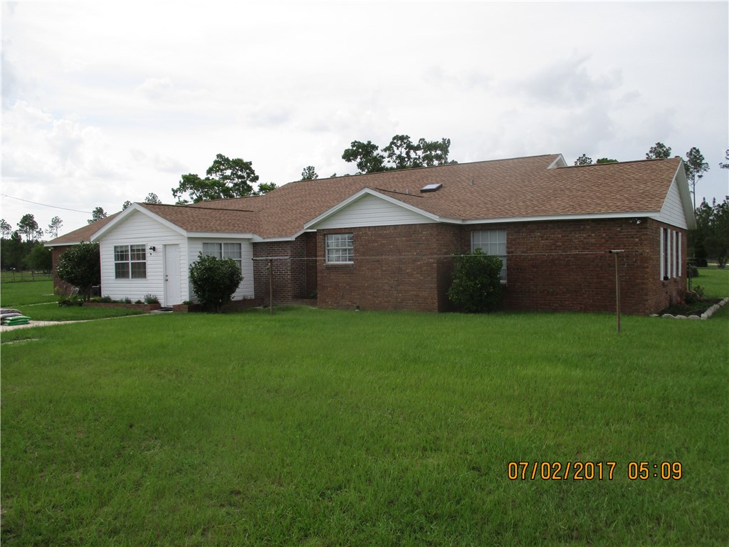 28296 Trigg Road Hilliard, FL 32046 - Photo 31 of 34 a front view of a house with a garden