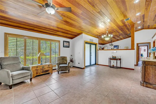 a view of living room with furniture and kitchen