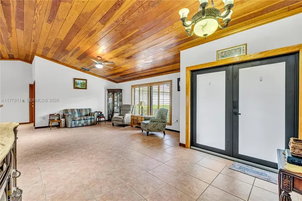 a bedroom with a bed and large mirror