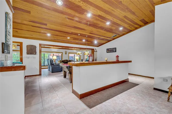 a open kitchen with a stove kitchen island and stainless steel appliances