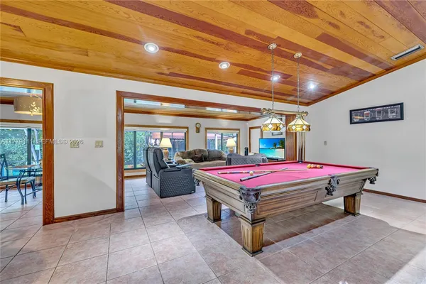 a kitchen with stainless steel appliances granite countertop a sink and a large window