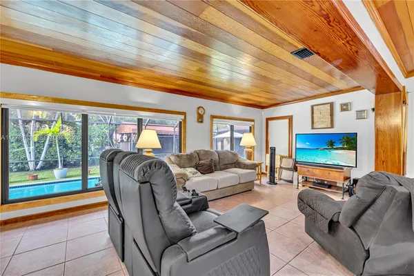 a view of a dining room with furniture and a chandelier