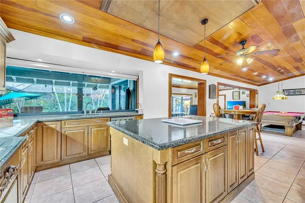 a bathroom with a tub a mirror and a shower