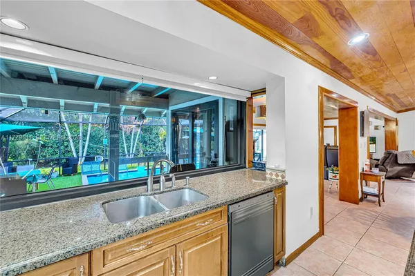 a bathroom with a granite countertop sink and a shower
