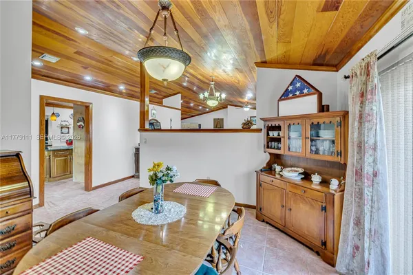 a bathroom with a granite countertop sink and a large mirror