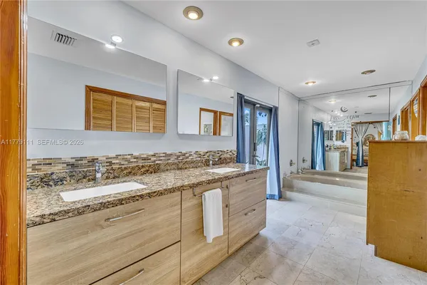 a bathroom with a toilet sink vanity and shower