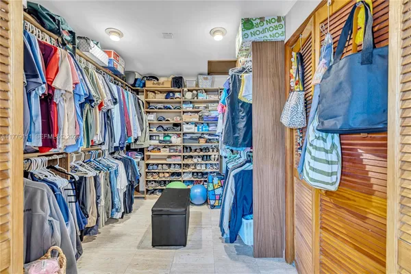 a dining room with stainless steel appliances granite countertop furniture and a large window