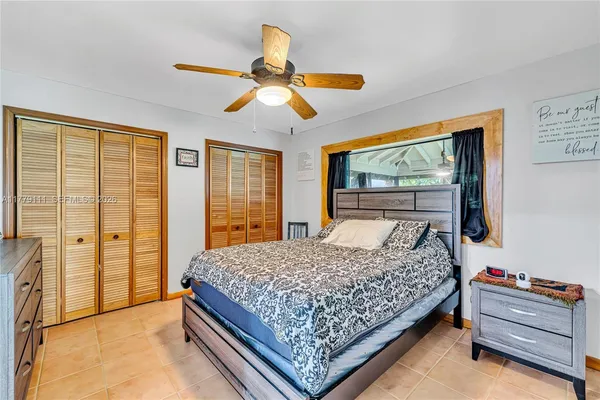 a bedroom with a large bed and a large window