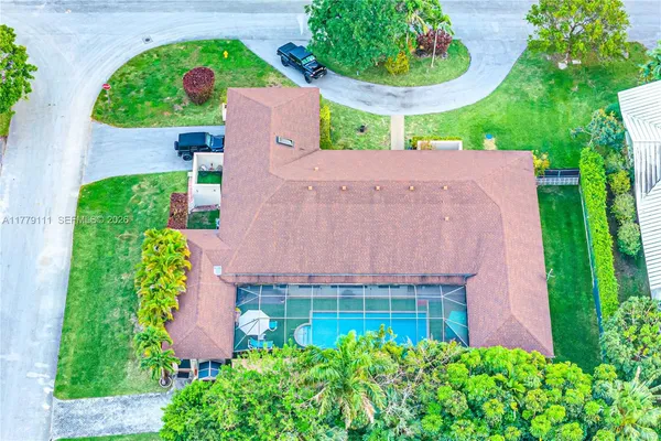 a view of a backyard with swimming pool table and chairs